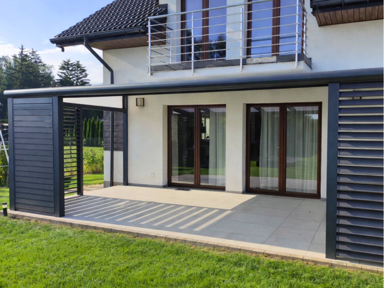 Zadaszenie tarasu w Abramowicach Prywatnych z mlecznym poliwęglanem i zabudową boczną